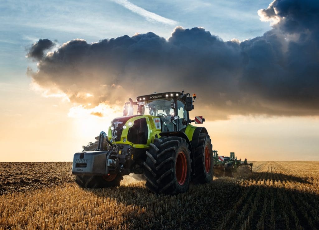CLAAS AXION with moody clouds behind it