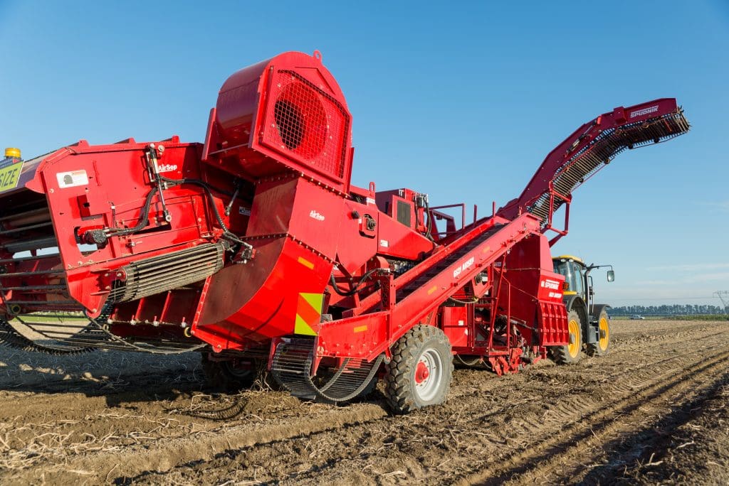 spudnik 6621 harvester being towed by a tractor