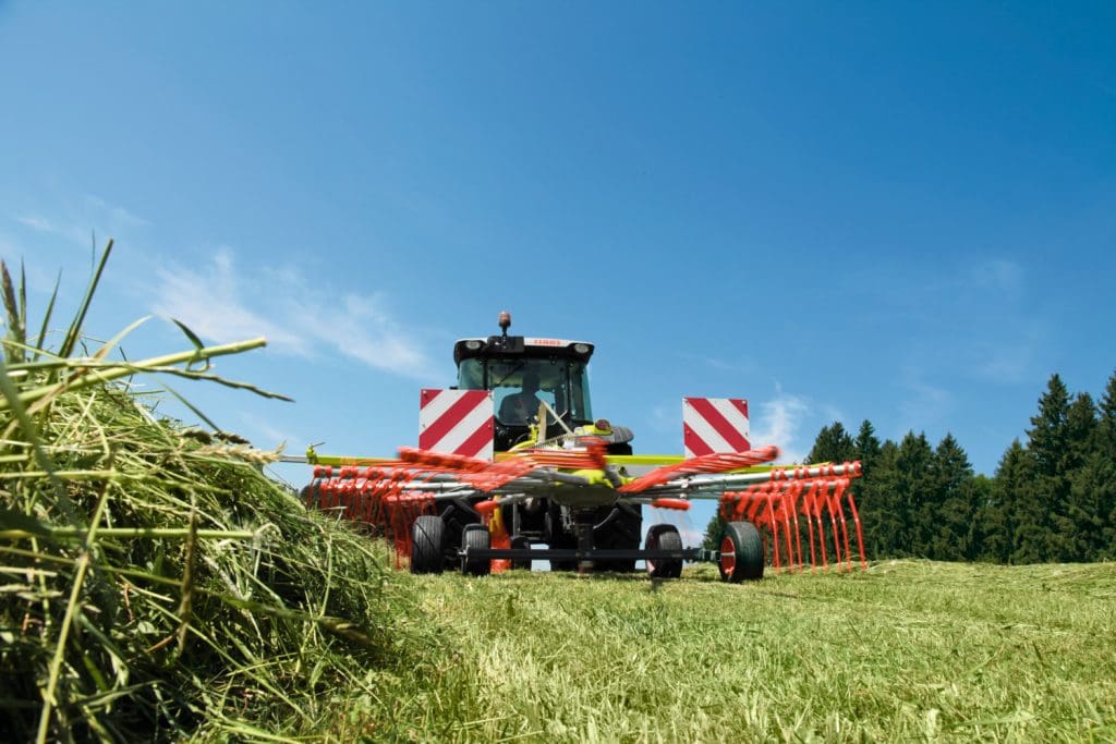 LINER swather or rake in action on a paddock