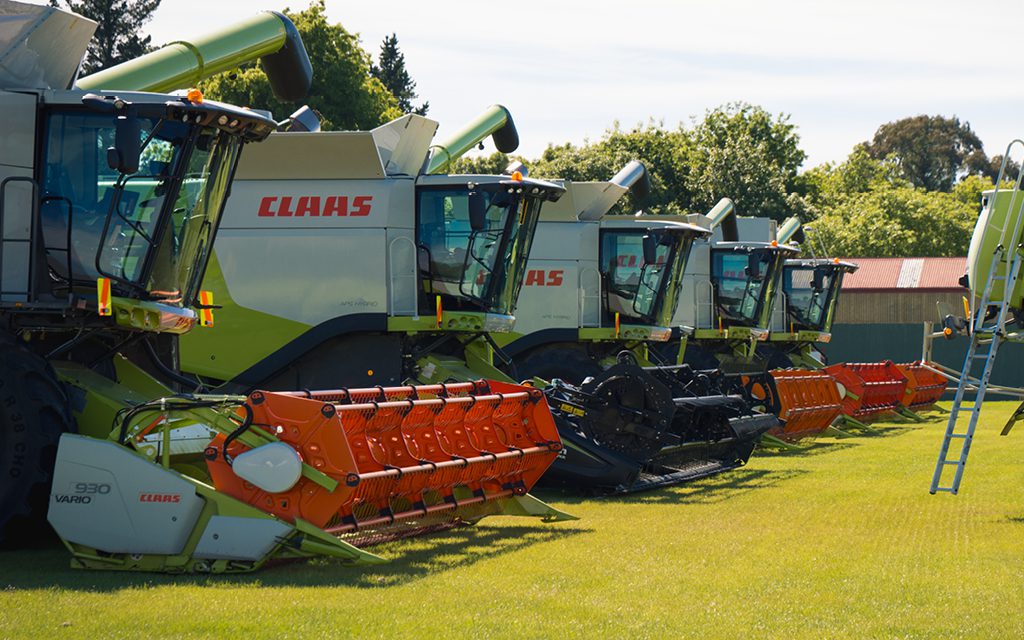 image of multiple claas lexion combine harvesters lined up ready for sale